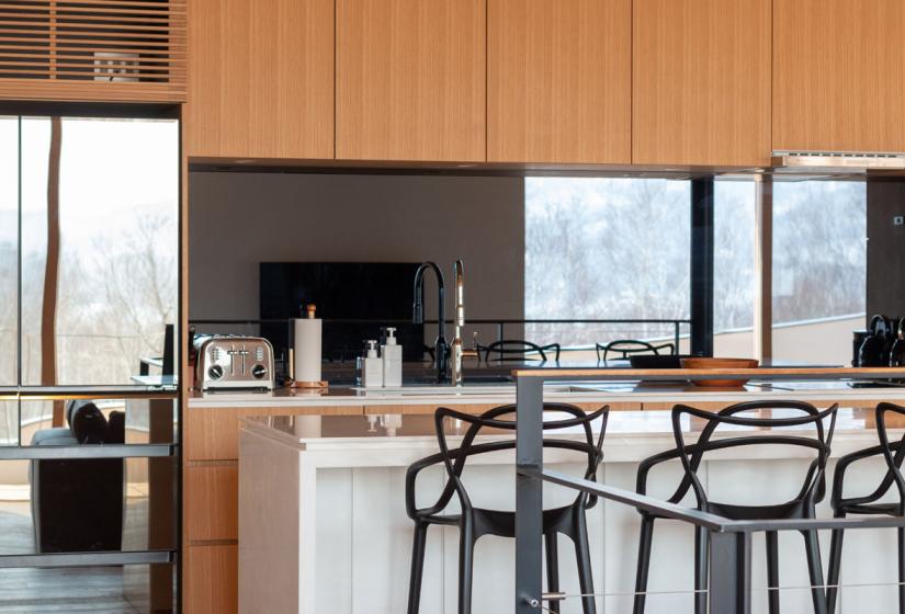 kitchen with bar and stools windows in background