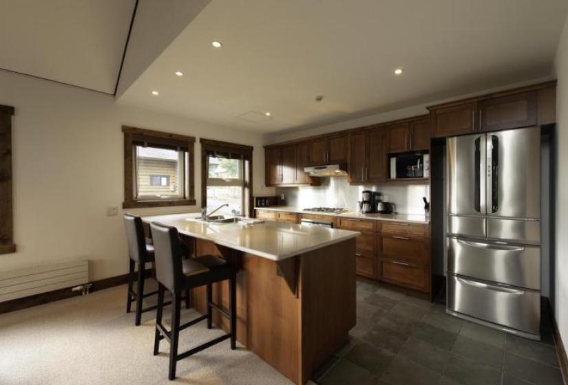 Kitchen island bench with kitchen behind