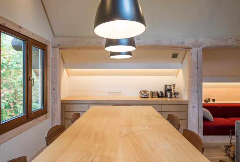 Wood dining table under three lights