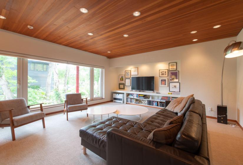 Leather sofa in living room with wooden ceiling