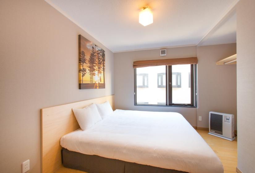 White bedspread and pillows, window and light