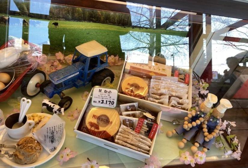 Dolls, snacks and a toy tractor on a display table