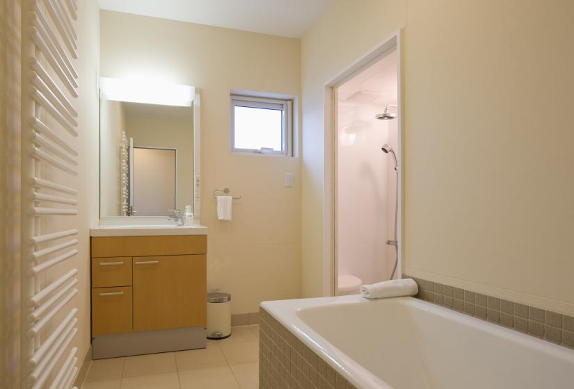 Bath tub with brown and white vanity unit