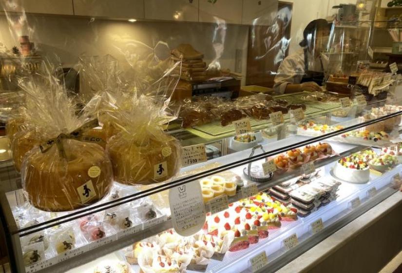 Rows of cakes and sweets in a display cabinet