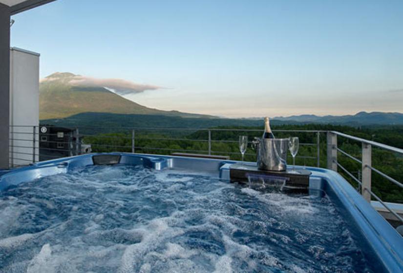 penthouse roof hot tub with summer view of yotei