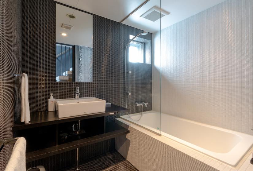 penthouse bathroom with tub and sink