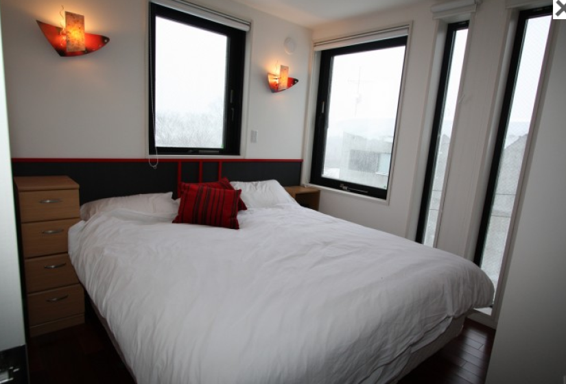 king bedroom with wall candle lighting and village view windows