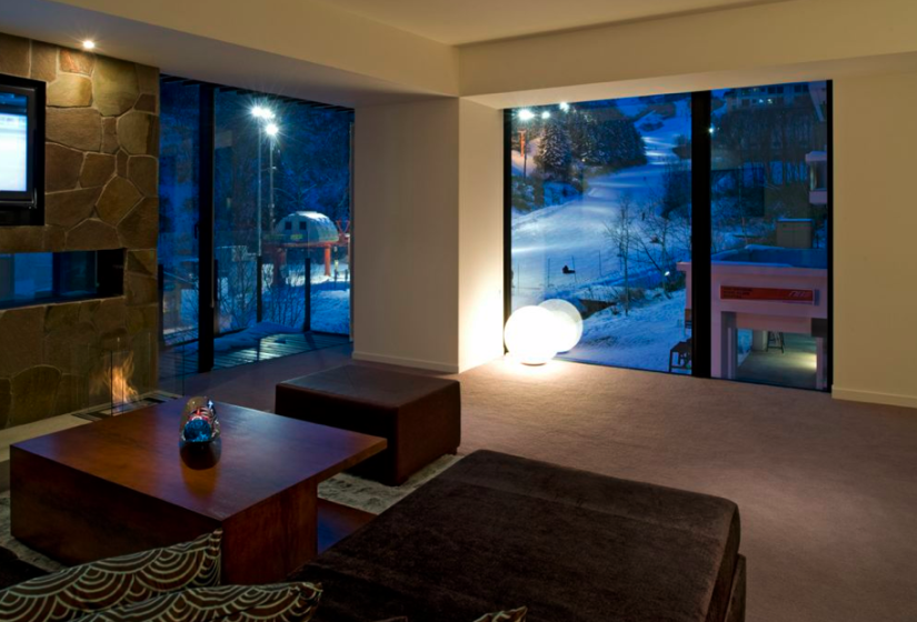 ski mountain view from living room with coffee table and large windows
