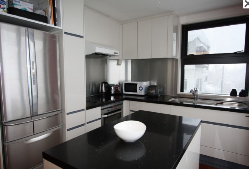 kitchen with island counter and double door stainless steel refrigorator