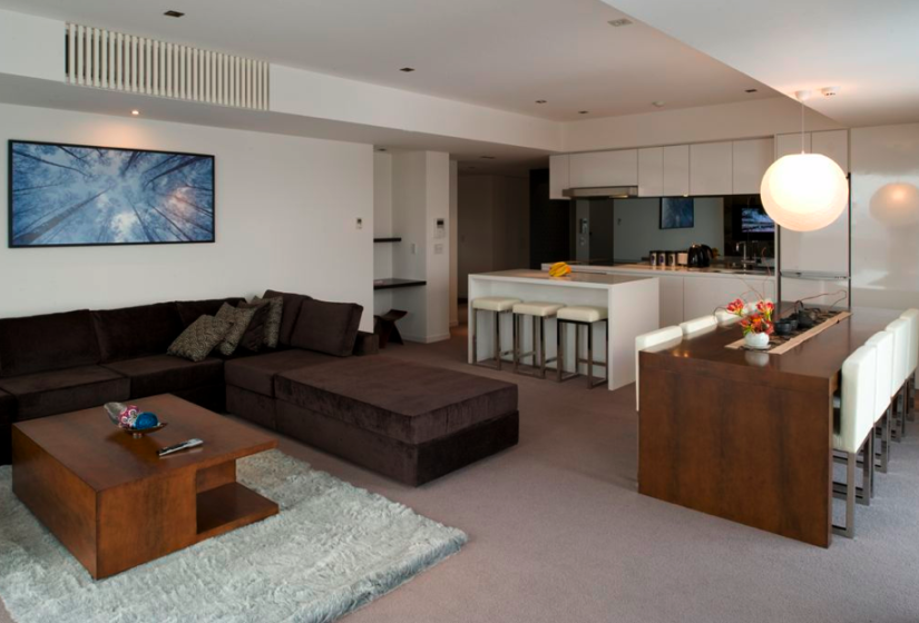 living area with bar stools at counter large couches, carpet