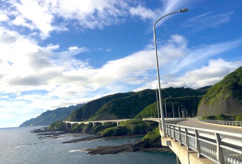 A large viaduct sweeps around the coast