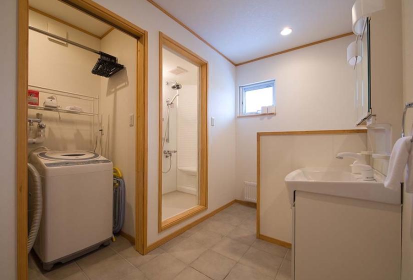 shower bathroom with laundry and wash machine