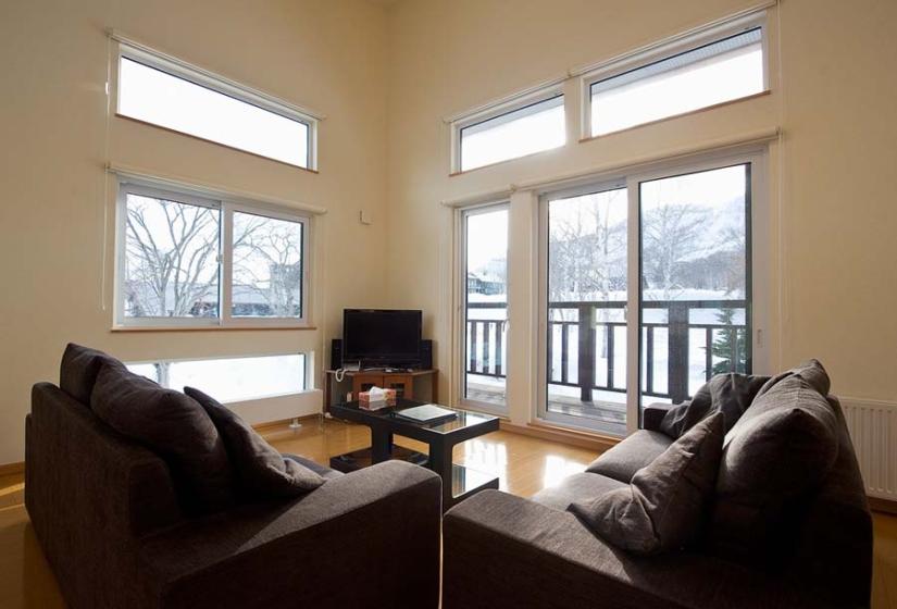 lounge area looking out large windows on to the deck