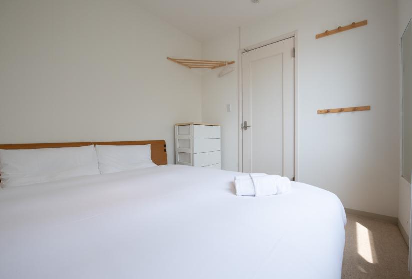 Sakura bedroom with double bed and white dresser