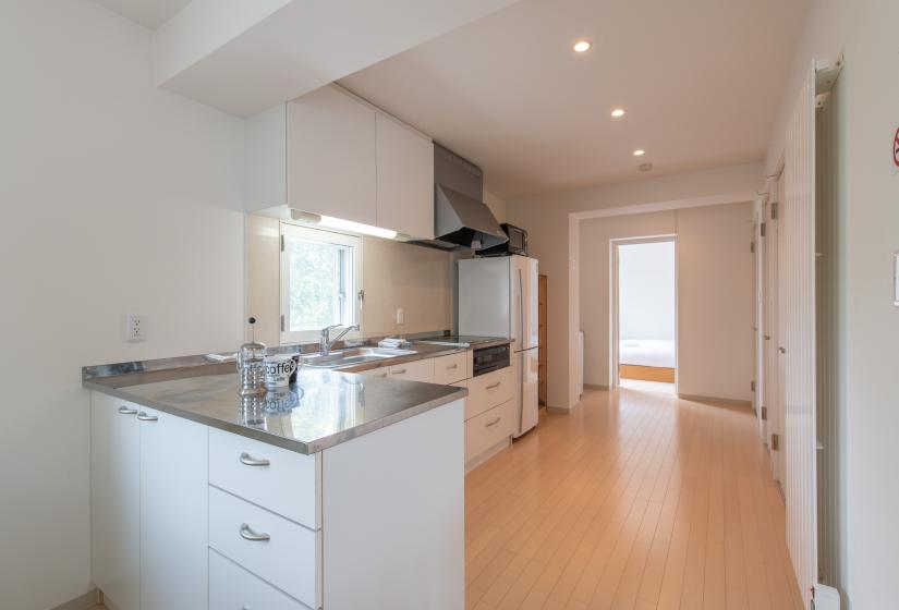 View from the living area into the kitchen and back bedroom