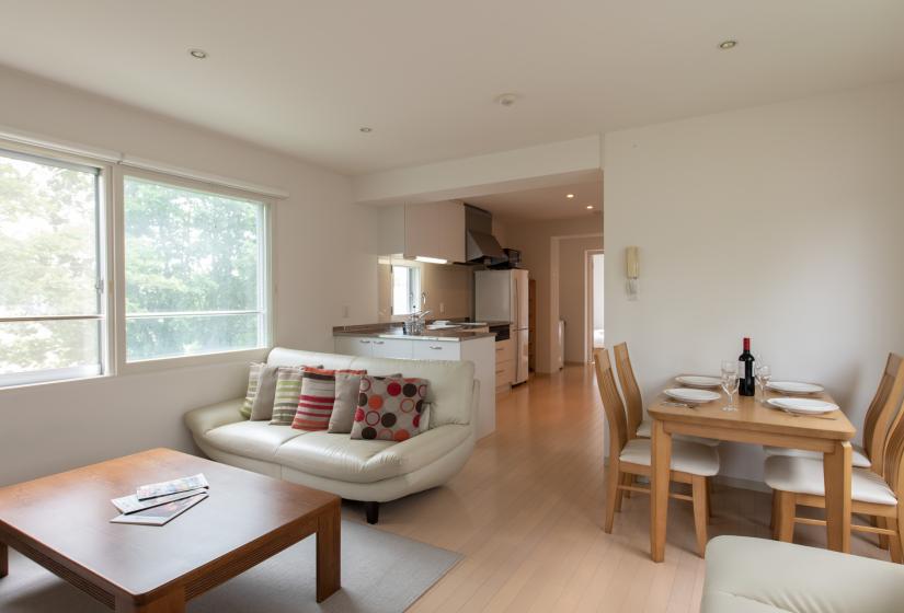 Living room couch and table with dining table using white crockery