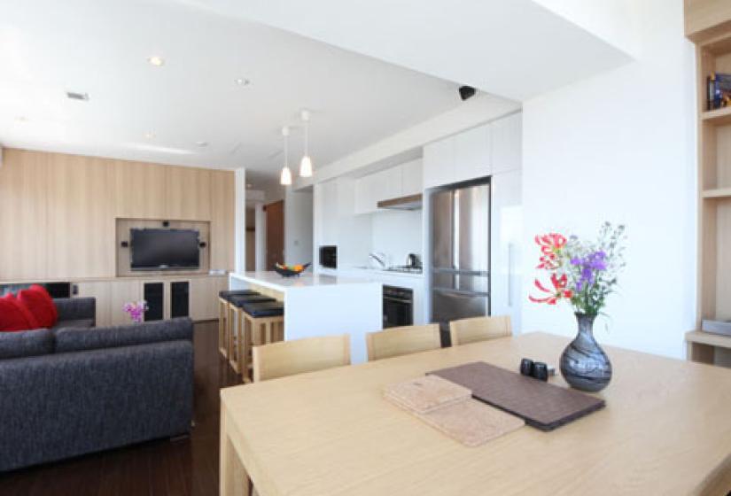 dining room table with tv, kitchen and barstools and island countertop