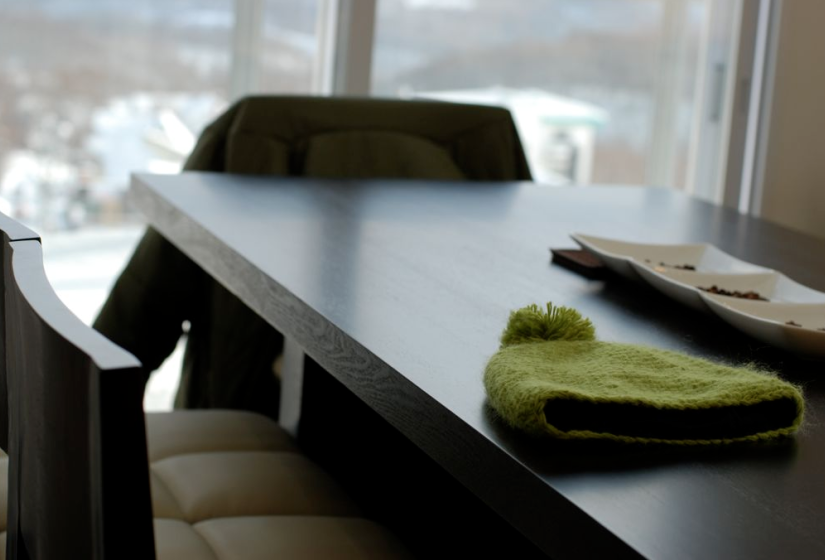 green hat rests on dining table