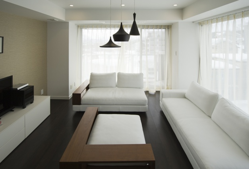 living room with sofas, foot rest, and tv