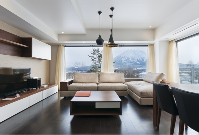 living area with tan sofas and flat screen tv