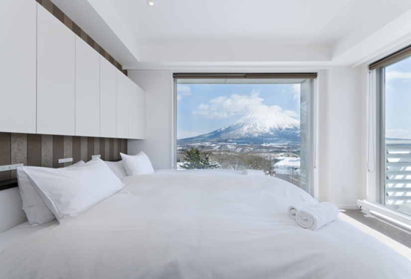 double bed made up in front of Mt. Yotei view from the window