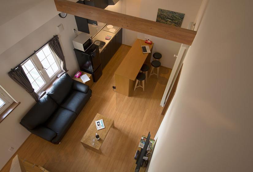 looking down on living and kitchen area from the loft