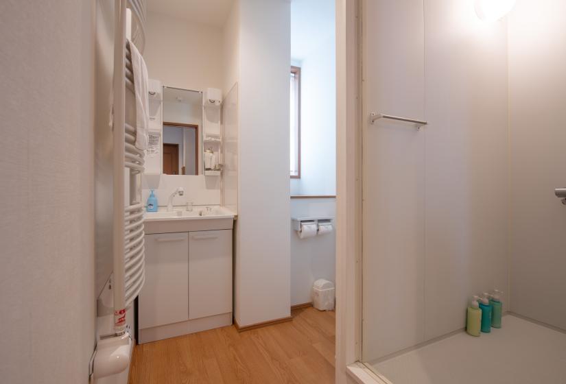 white vanity unit and unit shower