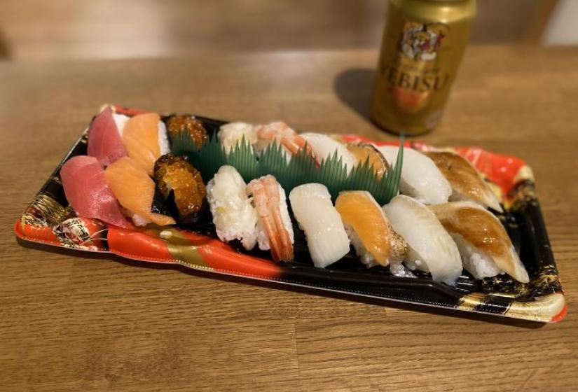 A selection of sushi in a decorative rectangle tray