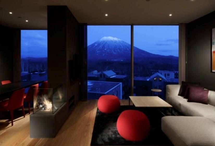 nighttime living room with tan sofa and red seats