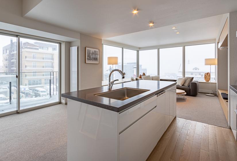 Island kitchen with view back to large windows