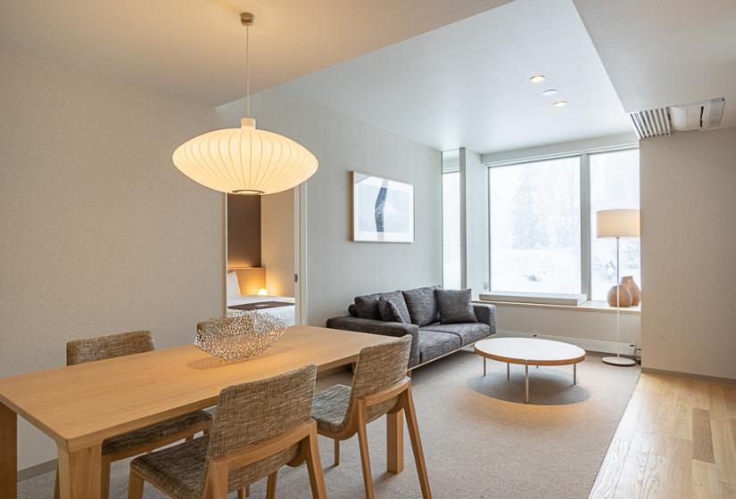 Dining table with coffee table and sofa in the background