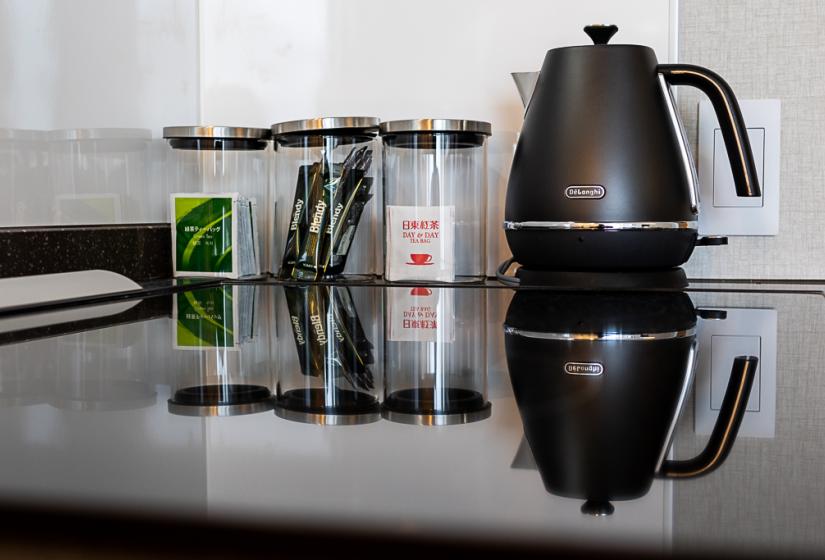 Kettle and tea and coffee sachets in jars