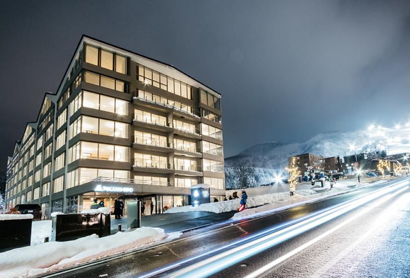 Exterior of 6 story Maples building with all lights on