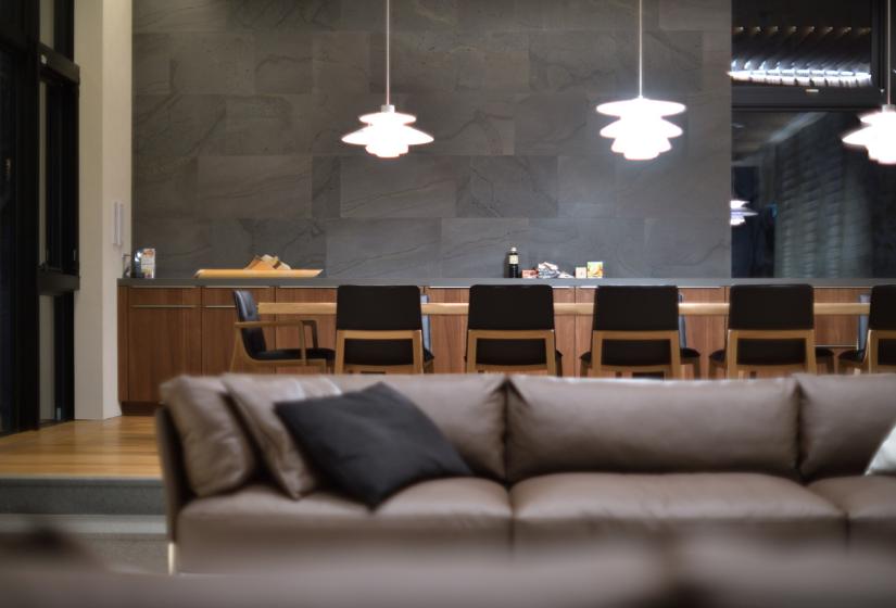 Hanging lights above a grey couch with black pillows