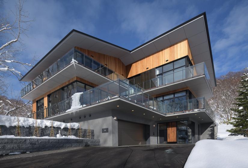 Large mansion with twin balconies and huge eves.