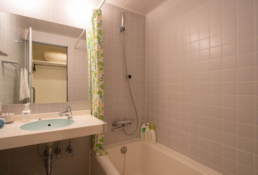 Bath with grey tile walls