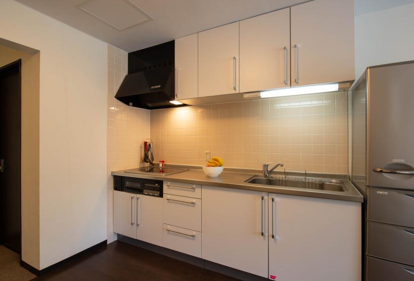 white kitchen unit with bowl of fruit on counter