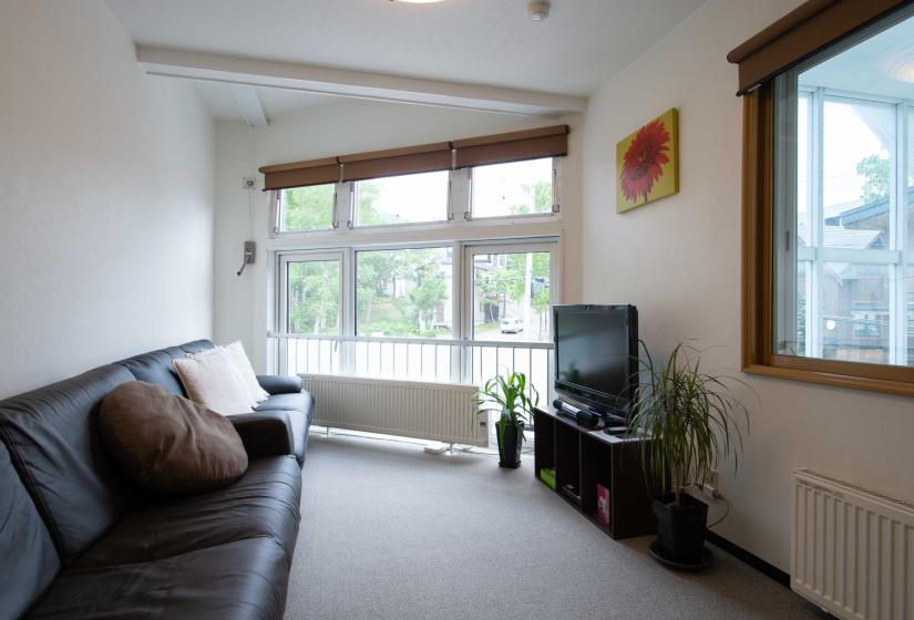 black sofas facing a TV in living room