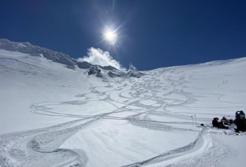 A view of ski tracks under blue skies