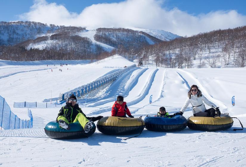 Snow tubing is fun for the whole family. A family snowtubing at Hanazono ski area