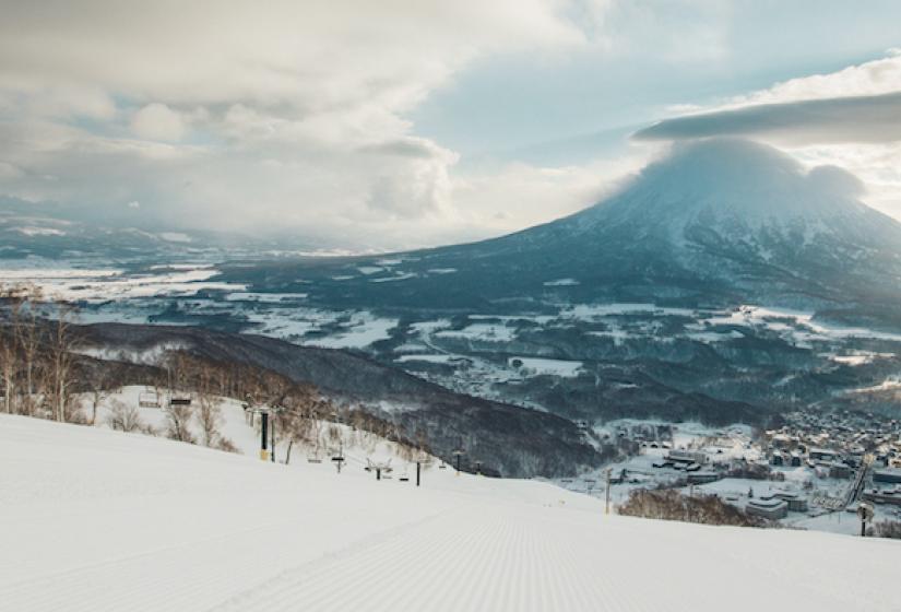 The view across a groomed slope with Mount Yotei in the back ground.