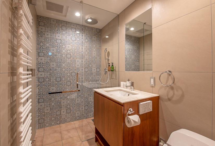 Grey titled shower with wooden vanity