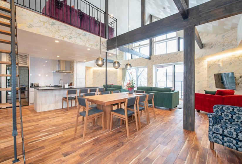 Wooden dining table in vaulted ceiling living room