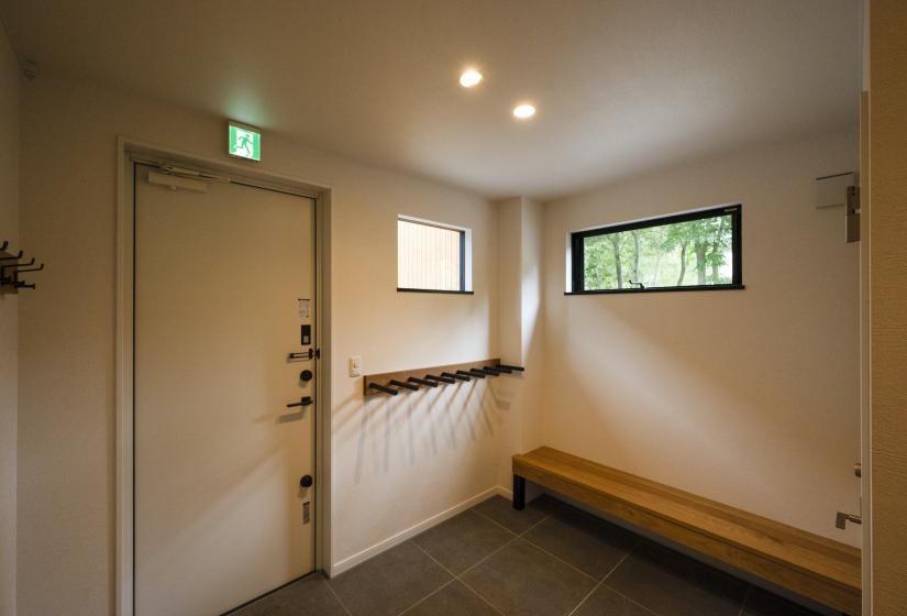 An entry way with ski racks and bench