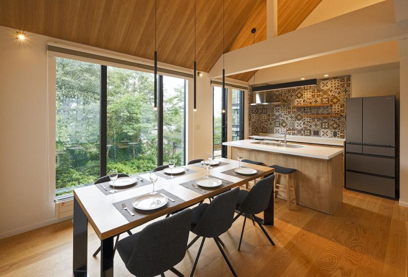 A set dining table with kitchen behind.