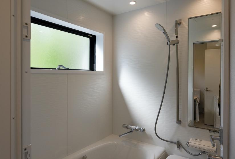 A white bath and shower unit