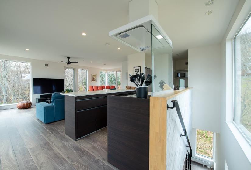 The corner of a kitchen with island bench in the back ground.