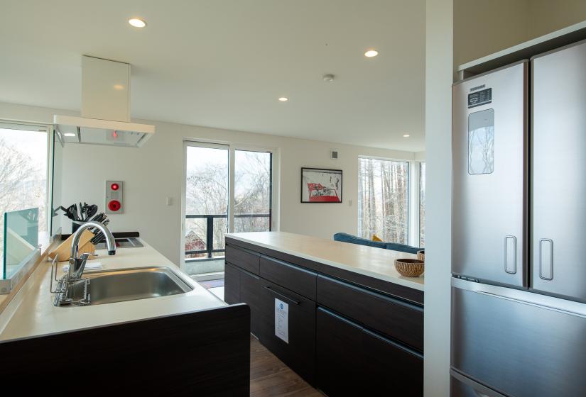 Two white kitchen benches with brown drawers below