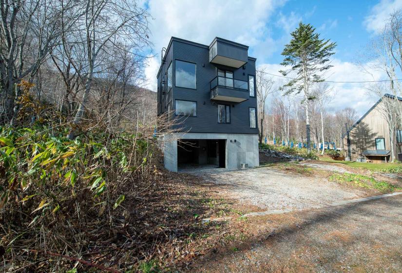 A large 3 story house with grey siding.