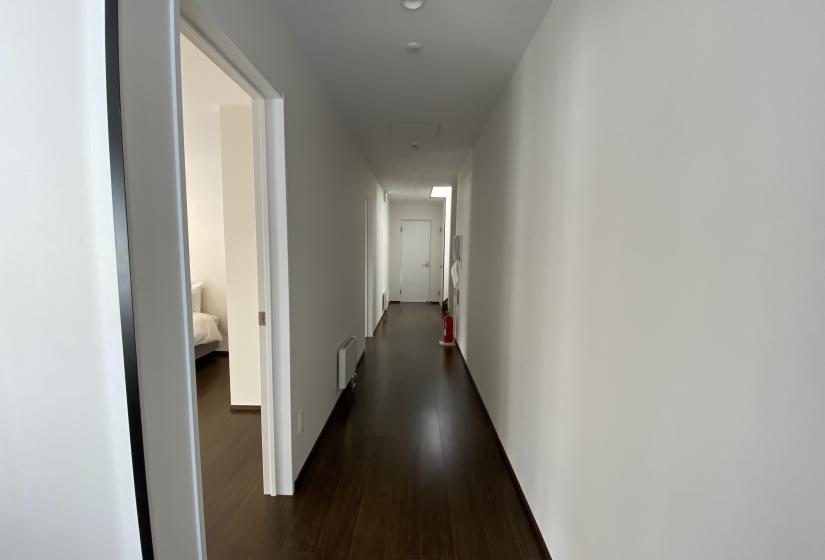 Hallway with dark wooden floors